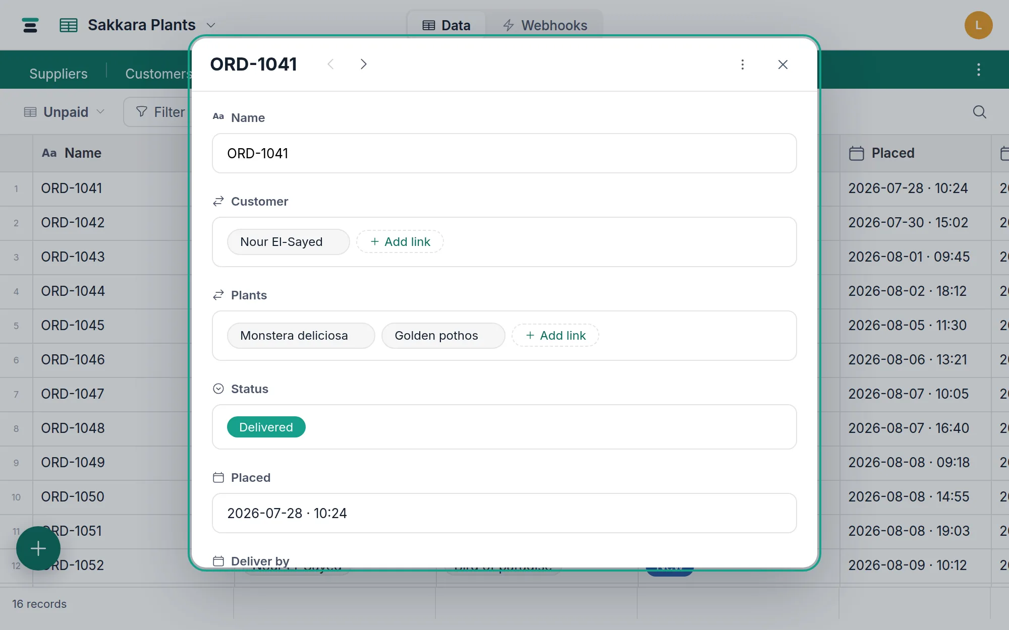 The record panel open on order ORD-1041 — every field of the record in one editable column, with prev/next arrows and the actions menu in the header.
